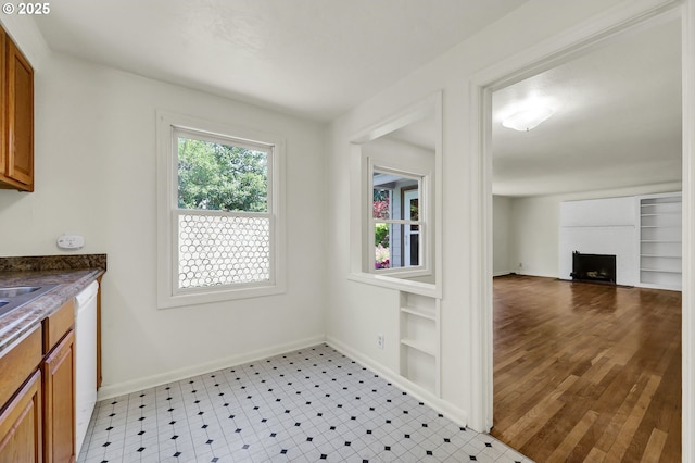 2674 Kincaid St, Eugene, OR 97405 - kitchen featuring brown cabinets, dishwasher, dark countertops, and a fireplace
