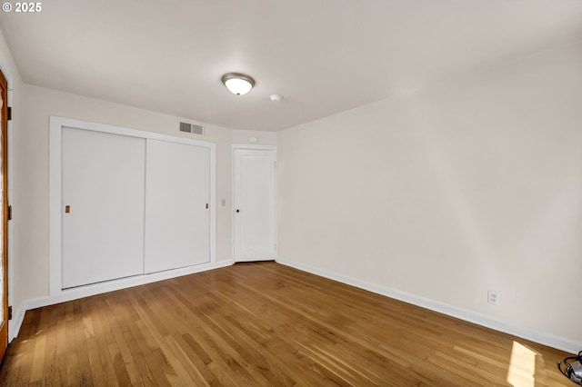 2674 Kincaid St, Eugene, OR 97405 - unfurnished bedroom featuring hardwood / wood-style flooring, baseboards, and a closet