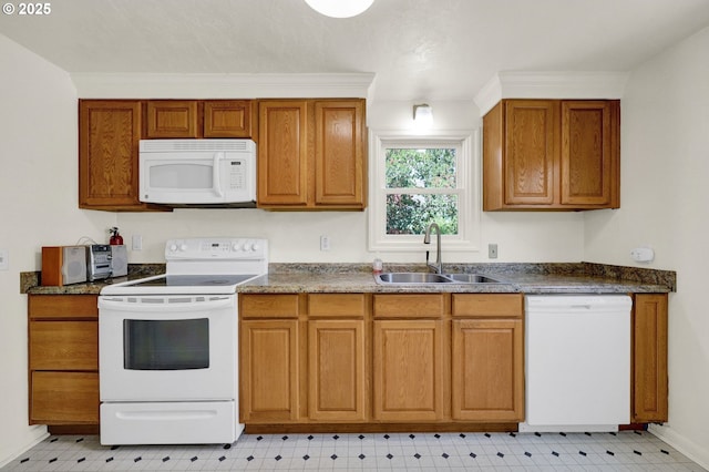 2674 Kincaid St, Eugene, OR 97405 - kitchen featuring white appliances, a sink, light floors, brown cabinets, and dark countertops