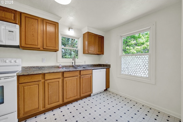2674 Kincaid St, Eugene, OR 97405 - kitchen with white appliances, a sink, baseboards, and brown cabinetry