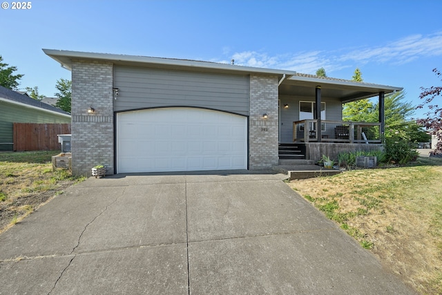 302 NW Elderberry Ln, Dallas, OR 97338 - view of front of property featuring brick siding, driveway, a porch, and an attached garage
