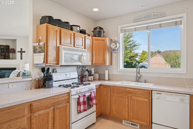 302 NW Elderberry Ln, Dallas, OR 97338 - kitchen featuring white appliances, light countertops, a glass covered fireplace, and recessed lighting