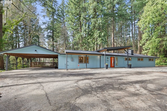 view of front of property with a carport and aphalt driveway