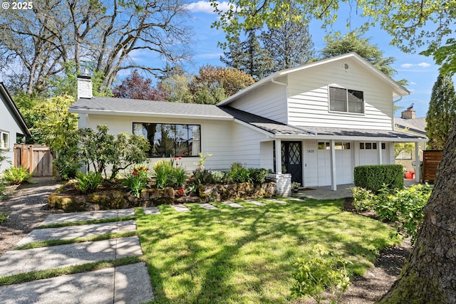 traditional-style home featuring a chimney, roof with shingles, and a garage