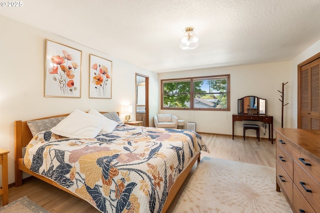 bedroom with wood finished floors and baseboards