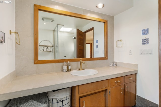 bathroom with a stall shower and vanity