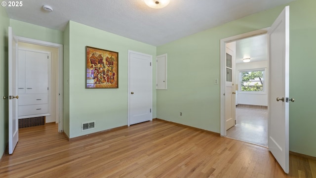4217 NE 19th Ave, Portland, OR 97211 - unfurnished bedroom featuring light wood finished floors and a textured ceiling