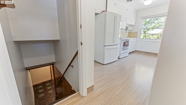 4217 NE 19th Ave, Portland, OR 97211 - kitchen with white appliances, white cabinetry, and light wood-style flooring
