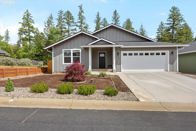 single story home with an attached garage, driveway, fence, and board and batten siding