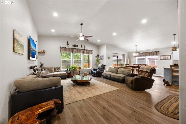 living area featuring wood finished floors, healthy amount of natural light, ceiling fan, lofted ceiling, and recessed lighting