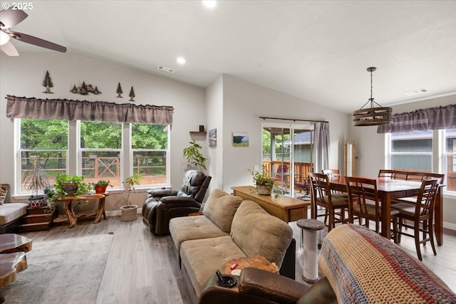 living room featuring lofted ceiling, wood finished floors, ceiling fan, plenty of natural light, and recessed lighting