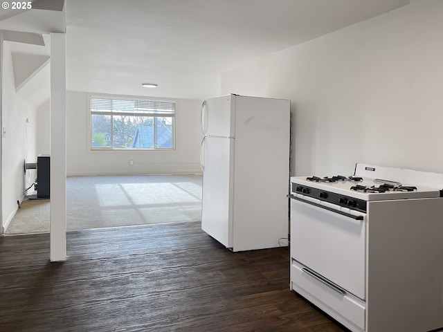 kitchen with white appliances, dark wood-style flooring, and baseboards