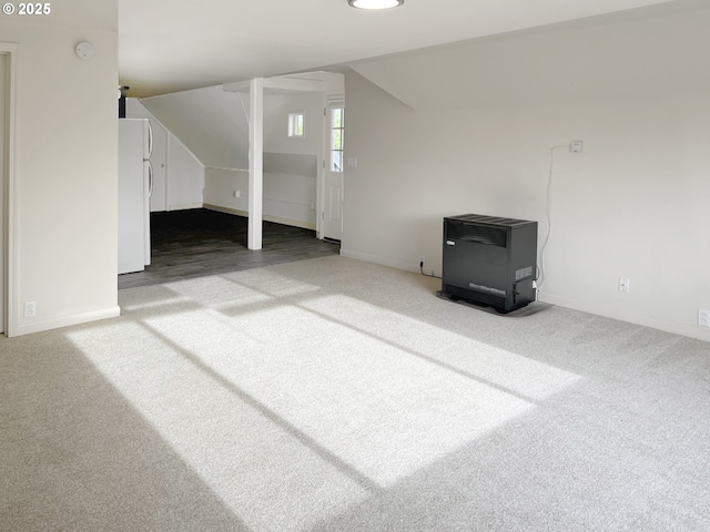 additional living space featuring lofted ceiling and carpet floors