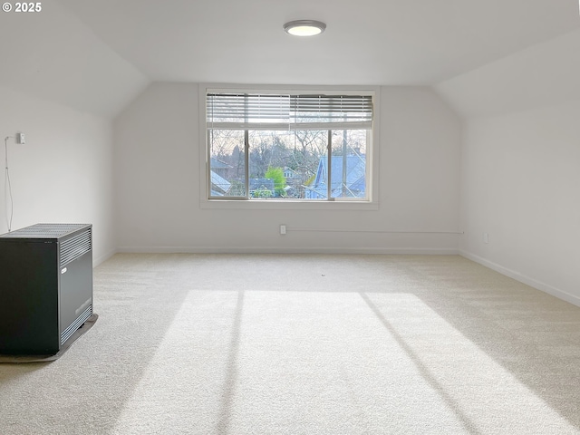 additional living space featuring vaulted ceiling, carpet flooring, and baseboards