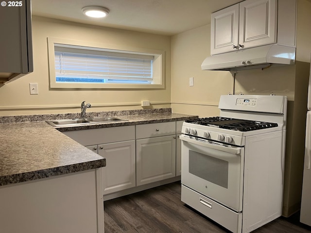 kitchen with white gas range oven, dark wood finished floors, under cabinet range hood, white cabinetry, and a sink