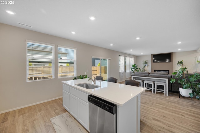 4829 Surveyor Ave, Salem, OR 97305 - kitchen with stainless steel dishwasher, a sink, light wood finished floors, plenty of natural light, and recessed lighting