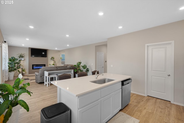 4829 Surveyor Ave, Salem, OR 97305 - kitchen with dishwasher, a sink, light wood-type flooring, light countertops, and recessed lighting