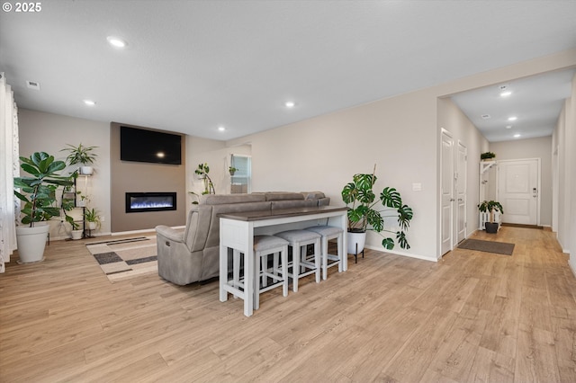 4829 Surveyor Ave, Salem, OR 97305 - living area with light wood finished floors, recessed lighting, a glass covered fireplace, and baseboards
