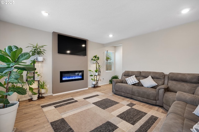 4829 Surveyor Ave, Salem, OR 97305 - living room with wood finished floors, baseboards, a glass covered fireplace, and recessed lighting