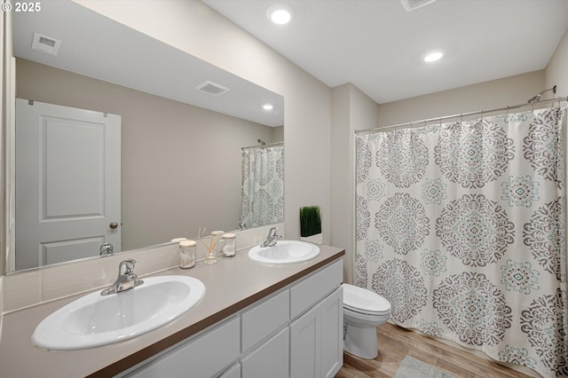 4829 Surveyor Ave, Salem, OR 97305 - bathroom featuring double vanity, toilet, wood finished floors, a shower with curtain, and recessed lighting