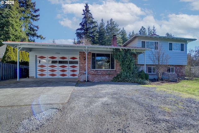 tri-level home featuring a garage and a carport