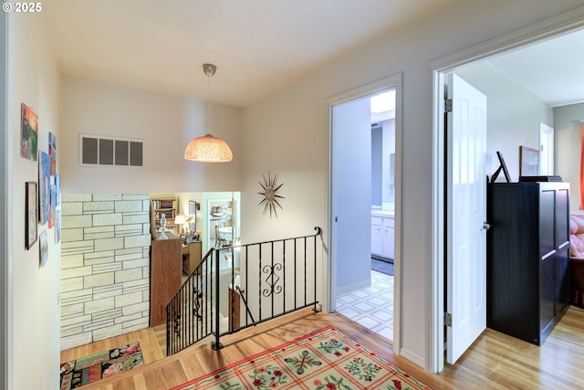 corridor with hardwood / wood-style floors