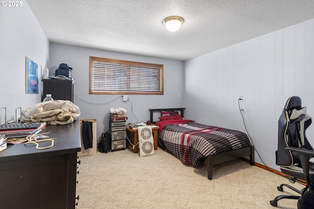 bedroom with light carpet and a textured ceiling