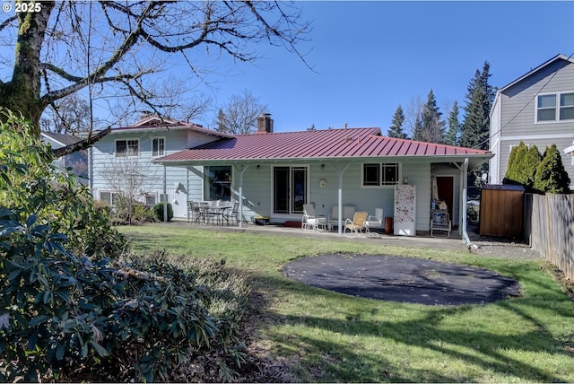 back of property featuring a yard and a patio area