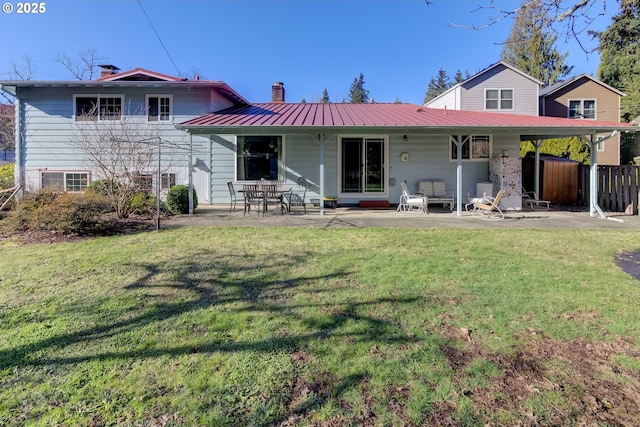 back of property featuring a yard and a patio