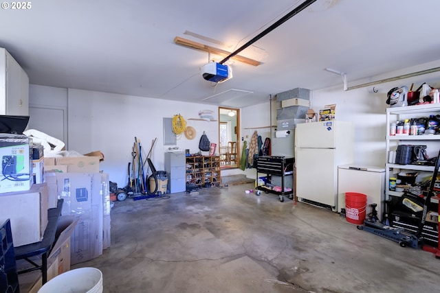 garage featuring a garage door opener and white refrigerator