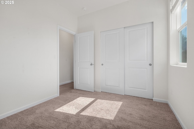 1712 W 12th St, La Center, WA 98629 - unfurnished bedroom featuring light carpet, baseboards, and a closet
