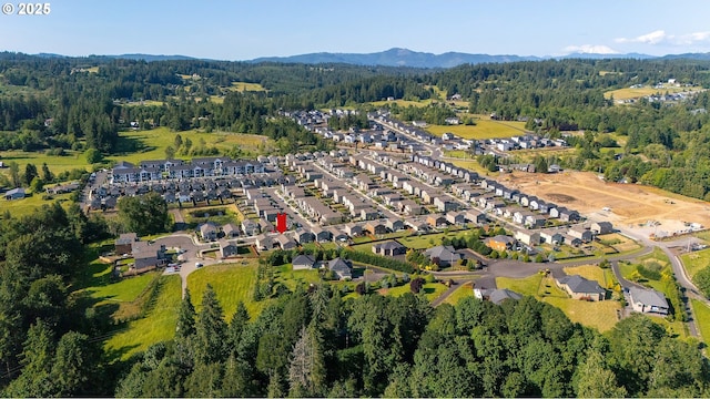 1712 W 12th St, La Center, WA 98629 - aerial view of property and surrounding area with a heavily wooded area, a mountain backdrop, and nearby suburban area