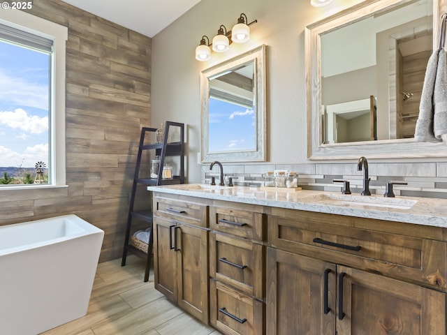 29349 SE Sunview Ln, Estacada, OR 97023 - full bathroom featuring wooden walls, double vanity, plenty of natural light, a soaking tub, and wood finished floors