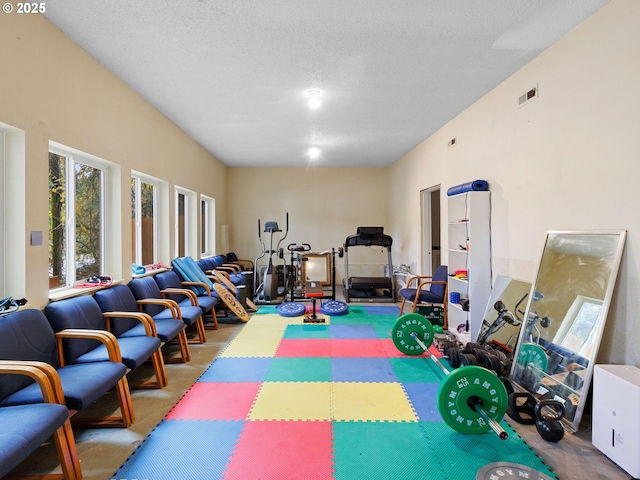 recreation room featuring carpet flooring and a textured ceiling