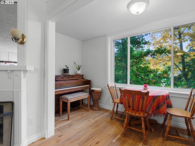 dining room featuring light wood-type flooring and ornamental molding