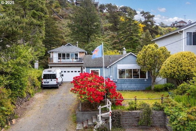 1745 Pearl St, Tillamook, OR 97141 - view of front facade with dirt driveway, a garage, and a shingled roof