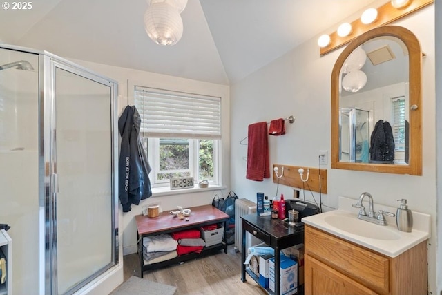 1745 Pearl St, Tillamook, OR 97141 - full bathroom featuring vaulted ceiling, a shower stall, wood finished floors, and vanity