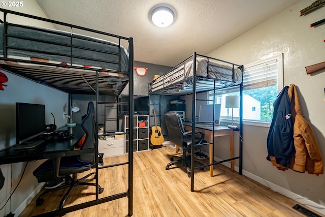 20131 Bridge Creek Rd SE, Silverton, OR 97381 - bedroom featuring wood finished floors, a desk, a textured ceiling, and a textured wall