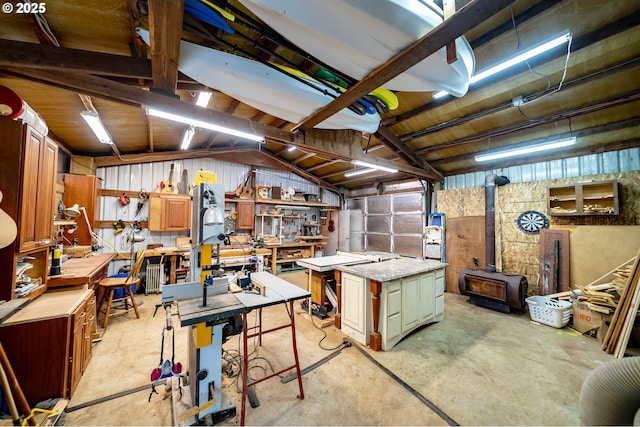 20131 Bridge Creek Rd SE, Silverton, OR 97381 - misc room with a workshop area, unfinished concrete floors, a wood stove, and vaulted ceiling