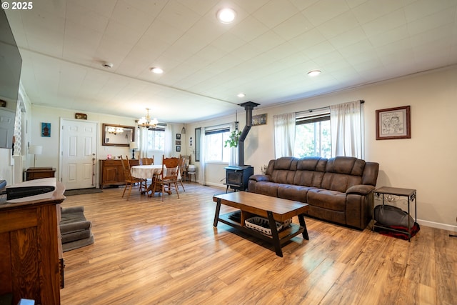 20131 Bridge Creek Rd SE, Silverton, OR 97381 - living area featuring a wood stove, a chandelier, light wood-style flooring, recessed lighting, and ornamental molding