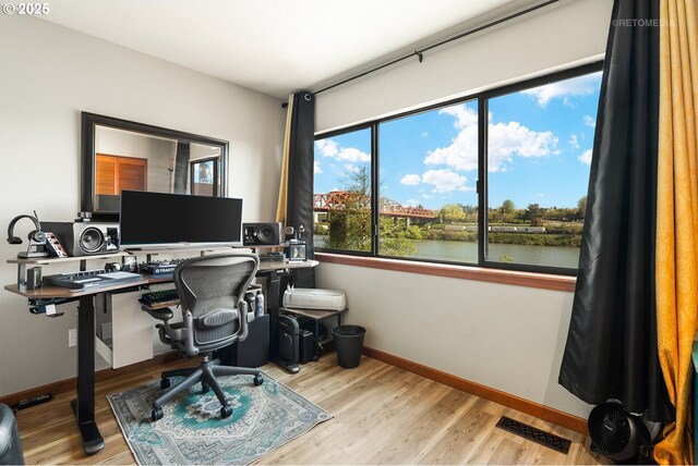 office area featuring baseboards, wood finished floors, and visible vents