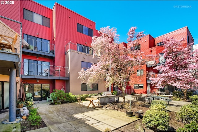 view of property's community with a patio area