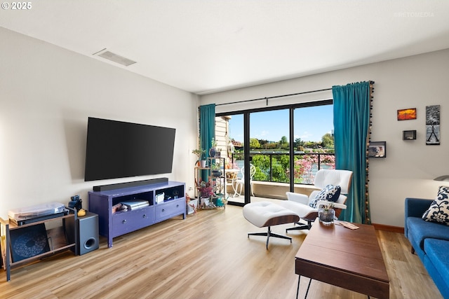 living area featuring wood finished floors and visible vents