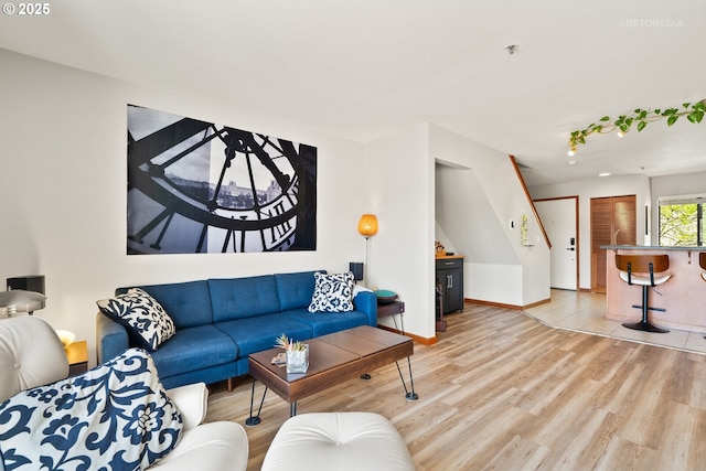 living area with light wood-style floors and baseboards