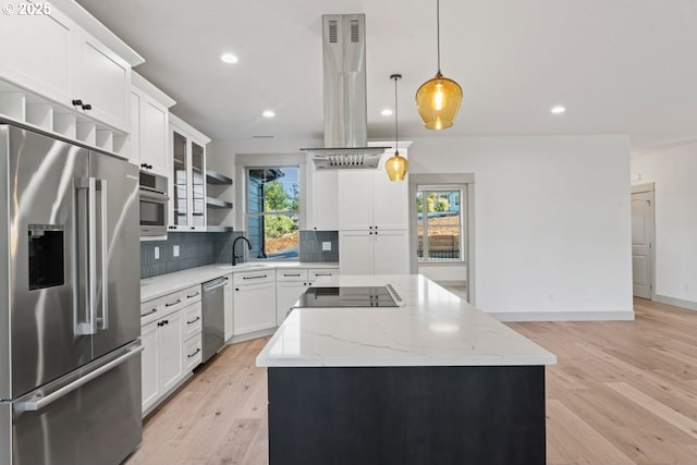 kitchen featuring white cabinetry, island range hood, decorative light fixtures, a kitchen island, and stainless steel appliances