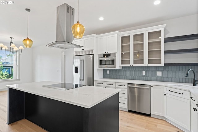 kitchen featuring sink, appliances with stainless steel finishes, white cabinetry, a center island, and island exhaust hood