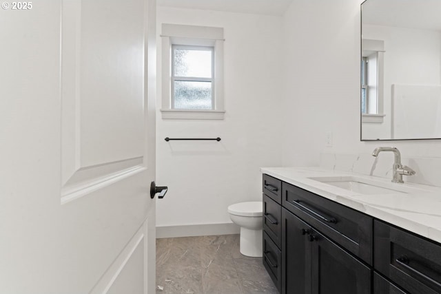 bathroom featuring vanity and toilet