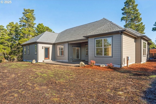 rear view of house with a yard and a patio area