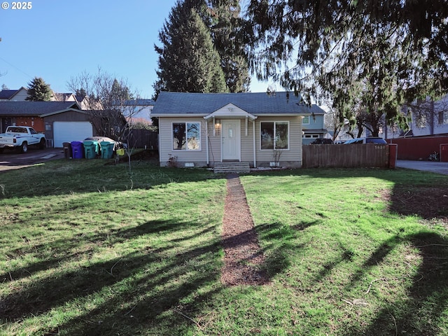 view of front facade featuring a garage, fence, and a front lawn