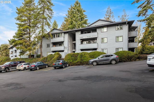 view of building exterior featuring uncovered parking